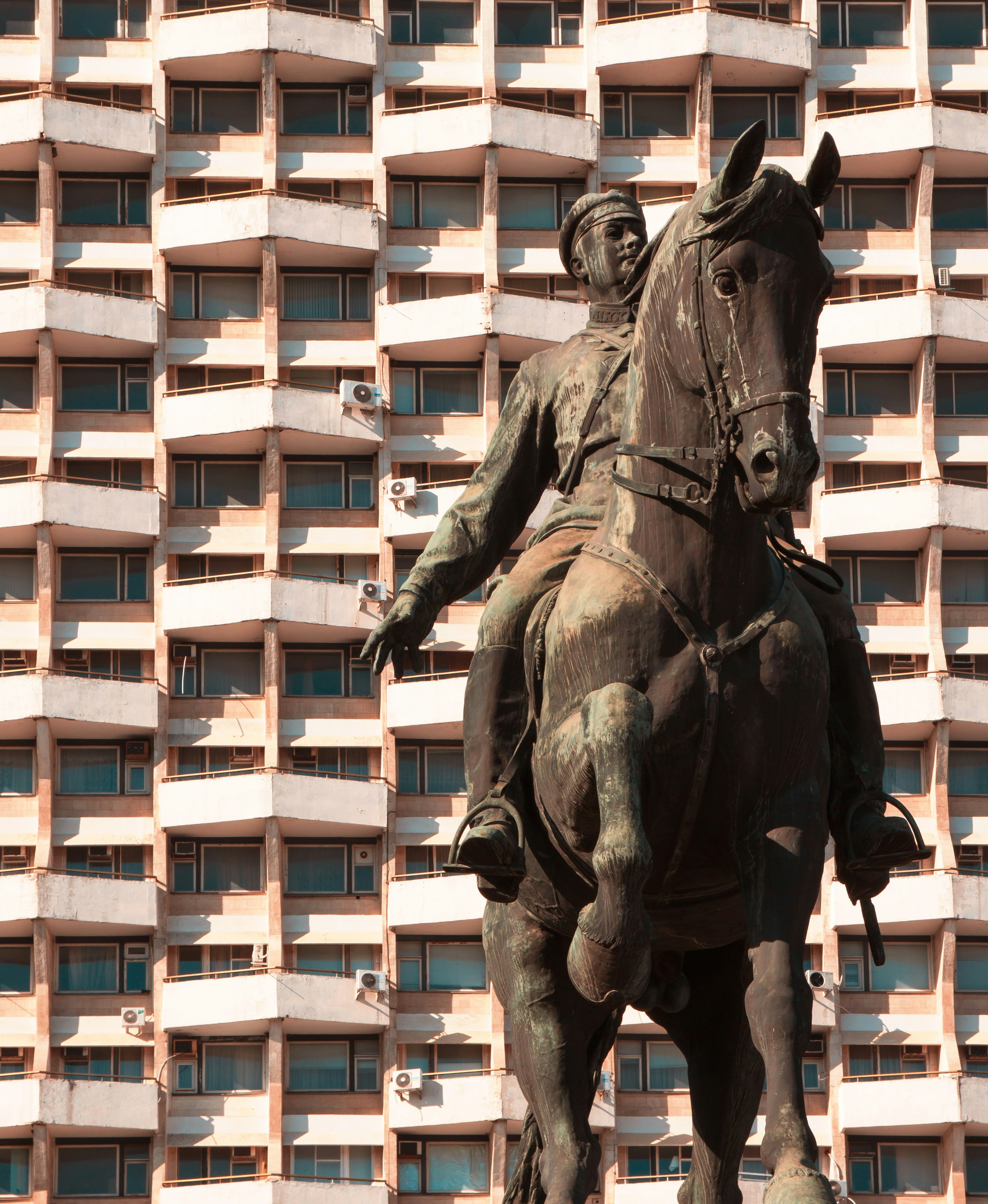 black horse statue near white building during daytime